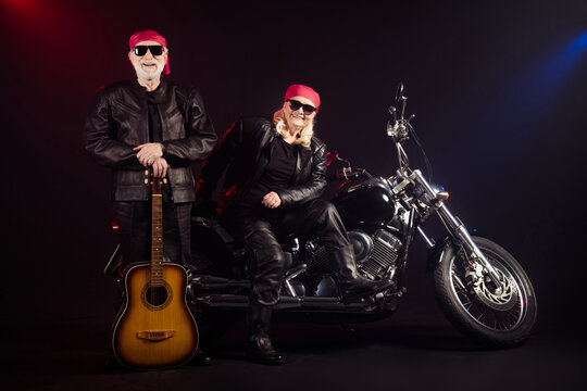 Full length photo of old two cool bikers man lady sit chopper rock festival play guitar famous popular metal band meeting wear trendy rocker leather outfit isolated black color background