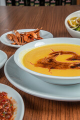 Turkish Traditional lentil Soup with bread on white rustic wooden background, mercimek corbasi.
