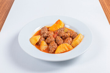 Turkish Traditional Soup with bread on white rustic wooden background, Izmir kofte yemegi.