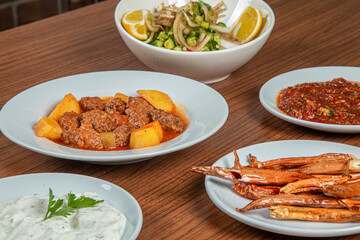 Turkish Traditional Soup with bread on white rustic wooden background, Izmir kofte yemegi.