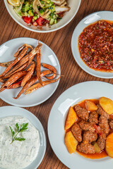 Turkish Traditional Soup with bread on white rustic wooden background, Izmir kofte yemegi.