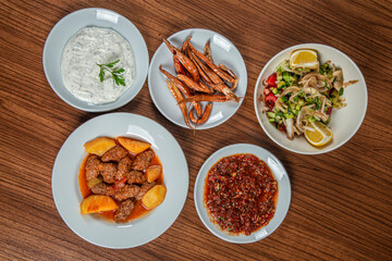 Turkish Traditional Soup with bread on white rustic wooden background, Izmir kofte yemegi.