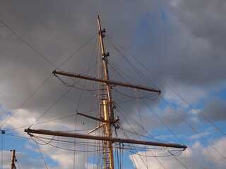 sail boat mast against stormy sky