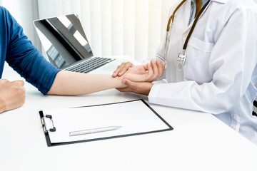 The doctor measures the wrist pulse, the heartbeat of the patient, and discusses health care closely