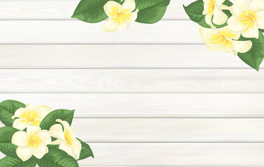 Tropical template for your design. Plumeria leaves on wooden background with empty space