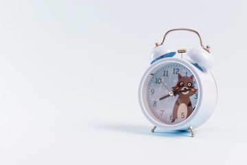 Alarm clock on blue background
