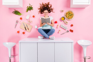 Top above high angle full length photo positive chef girl sit table read book want decide cook...