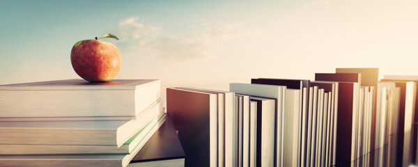 Apple on stack of books. Education, science and reading concept.