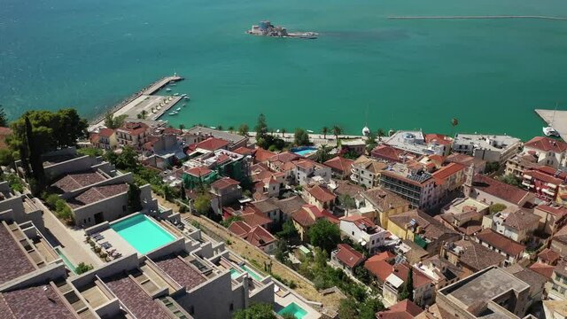 Aerial drone video of picturesque and historic old town of Nafplio in the slopes of Palamidi fortress and Acronafplia, Argolida, Peloponnese, Greece