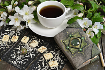 Tarot cards layout with runes and book of spells on witch table. Esoteric, gothic and occult background with magic objects, mystic and fairy tale concept