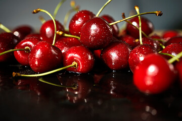 juicy red cherries on a black stone table