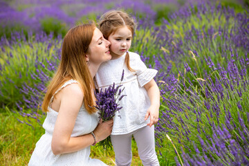 Mother walks with her little daugher holding a bouquet of lavander, Czech republic