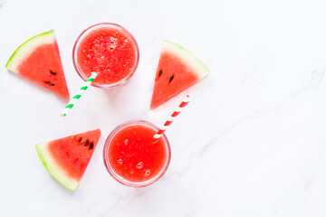Fitness, healthy nutrition diet concept. Fresh cool watermelon juice in two glass and watermelon slices on a light background. Summer concept. top view flat lay
