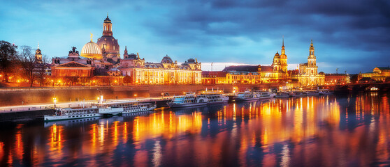 Fototapeta na wymiar Fantastic, evening cityscape of Dresden, Old Historical Town with Reflection in Elbe River in the foreground. Panoramic image of Dresden, Germany during sunset. Wonderful Picturesque Scene.