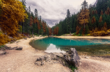 Wonderful Autumn landscape. Braies Lake in Dolomites mountains. Lago di Braies - Best Popular places for Photographers. Majestic Dolomiti rock mountains. Popular travel and hiking place in the nature.