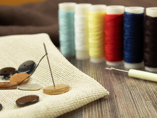 Background for text multi-colored threads and needle for needlework