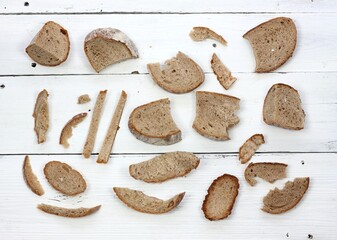 Dry bread on white table, flat lay.Remains of dry bread good for animals. Do not waste with food.