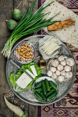 Still life with homemade milk cheese vegetables and herbs. The view from the top.