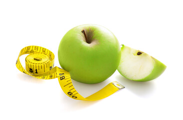 Yellow measure tape and green apple