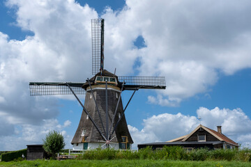 Fototapeta na wymiar Traditional dutch windmill near the canal. Netherlands.
