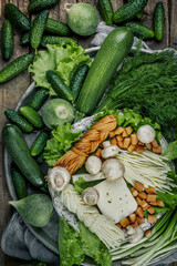 Still life with homemade milk cheese vegetables and herbs. The view from the top.