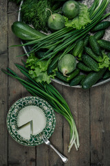 Still life with homemade milk cheese vegetables and herbs. The view from the top.