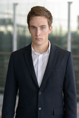 Portrait of young handsome businessman at the airport