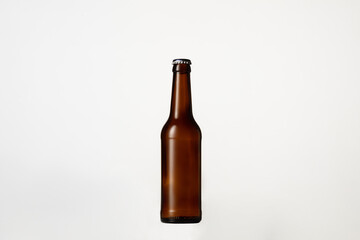 Empty golden colored beer bottle. One object isolated on white studio background. Concept of beer, beverage, entertainment and alcohol. Copyspace for your bar, restaurant, brewery or shop advertising.