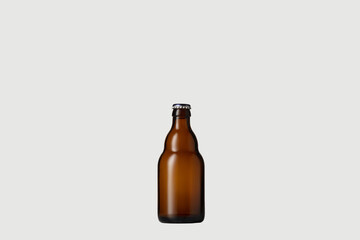 Empty golden colored beer bottle. One object isolated on white studio background. Concept of beer, beverage, entertainment and alcohol. Copyspace for your bar, restaurant, brewery or shop advertising.
