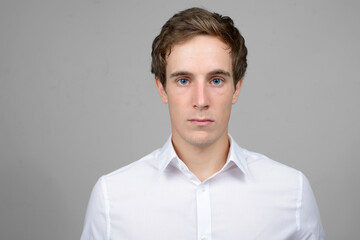 Face of young handsome businessman looking at camera