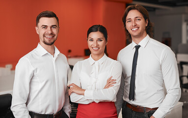 Diverse colleagues smiling during work in office