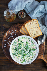 Russian traditional cold soup okroshka. Summer cold soup with yogurt and vegetables.