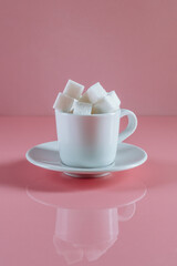 Sugar on a pink background. Art photo. Minimalism.