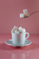 Sugar on a pink background. Art photo. Minimalism.