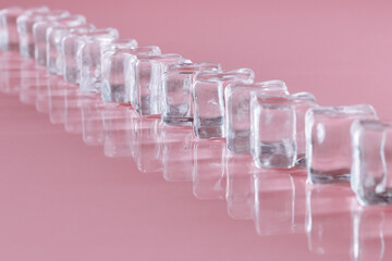 Ice cubes on a pink background. Art photo. Minimalism.