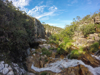 Fototapeta na wymiar Large canyon with a small river running across the rocks at Serra da Canastra region in Brazil.