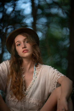 Beautiful young girl wearing a lace top posing in a dark forest