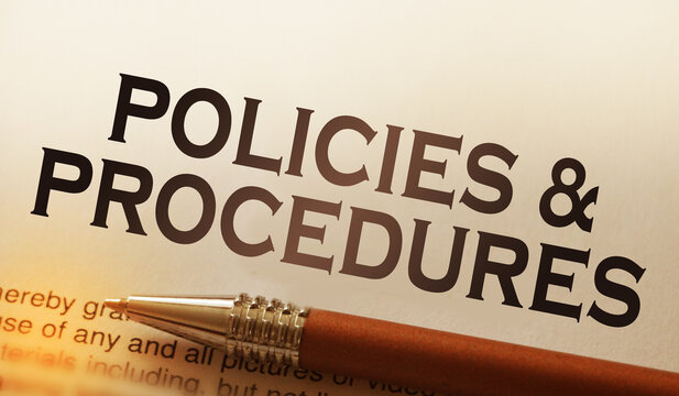 Policies and procedures memo on notebook with pen. Business concept