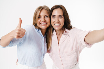 Image of women showing thumb up while taking selfie photo