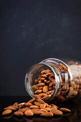 Almonds nuts in a jar. Set of nuts isolated on dark background