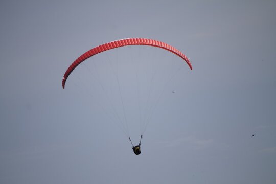 Closeup shot of a red paraplane on an empty sky
