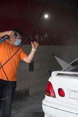 man with bow tie and car