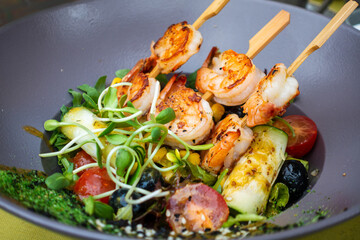 Delicious Spanish tapas made with black bread and prawns on top