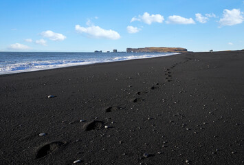 Black sand in Vik Reynisfjara beach steps Iceland Atlantic ocean