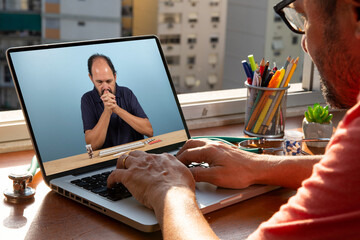 doctor talks to his patient via telemedicine during the coronavirus pandemic at his front-to-window residence