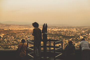 silhouette of a man standing on the telescope