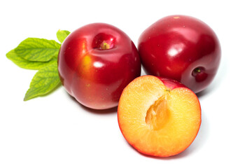 Plum fruit with plum leaf isolated on a white background