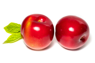 Plum fruit with plum leaf isolated on a white background