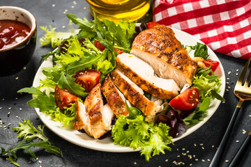 Grilled chicken with fresh salad at black.