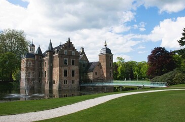 Historic castle with glass bridge and towers in a park with trees in the background. 16th century dutch architecture. Famous landmarks of the netherlands. 